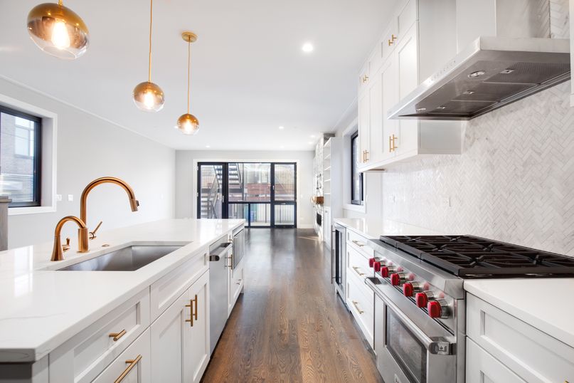 White residential kitchen with cabinetry and countertops